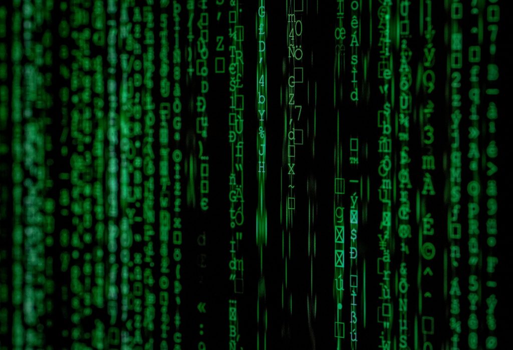 pexels-photo-1089438-1089438 Abstract green matrix code background with binary style.
